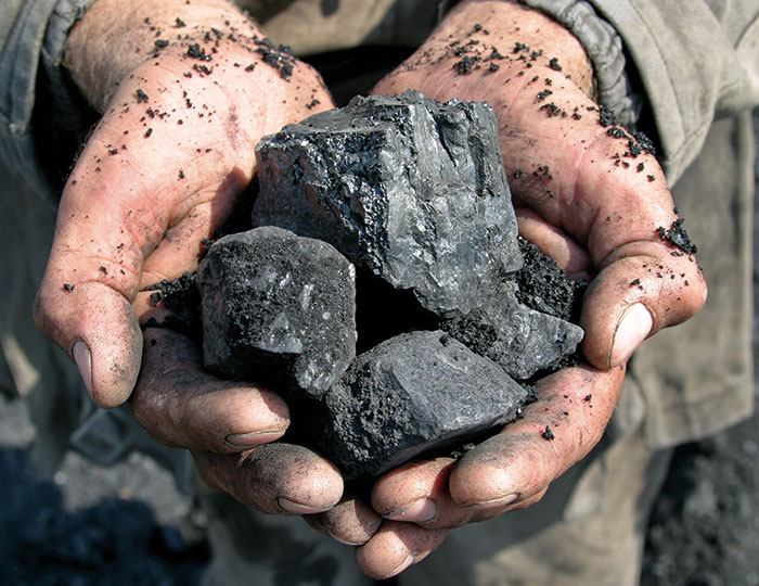 Hands holding iron ore