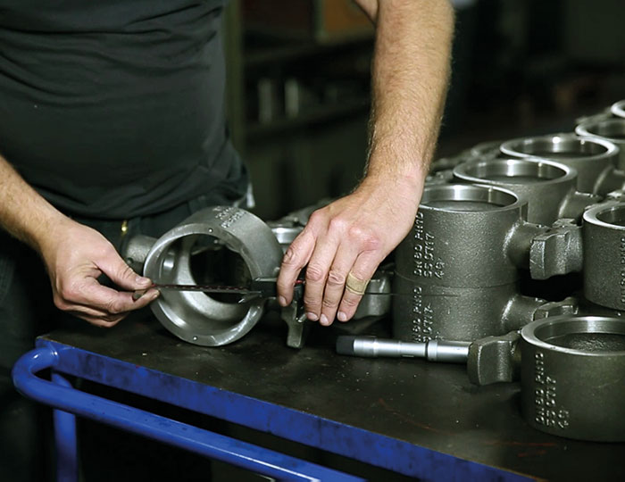 RaménKS_manufacturing Hands using measuring tool for quality assurance on a Ramén Ball Sector Valve