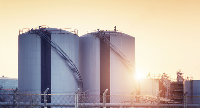 Storage tanks at sunset